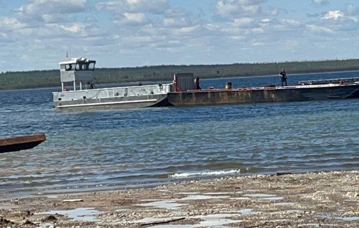 Spud barge pushed by tug on Lake Athabasca